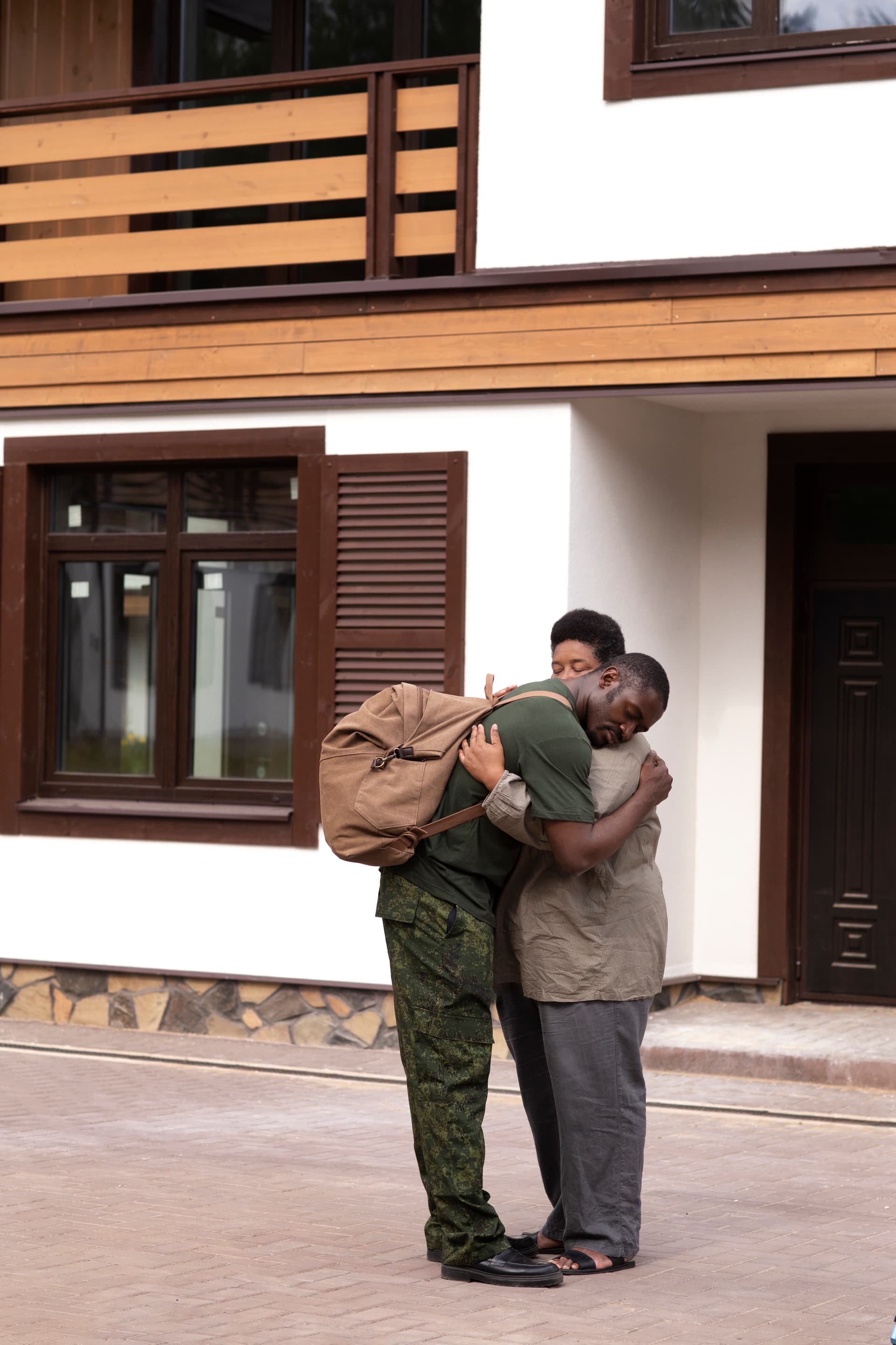 Stock photo: a uniformed service member embracing family members