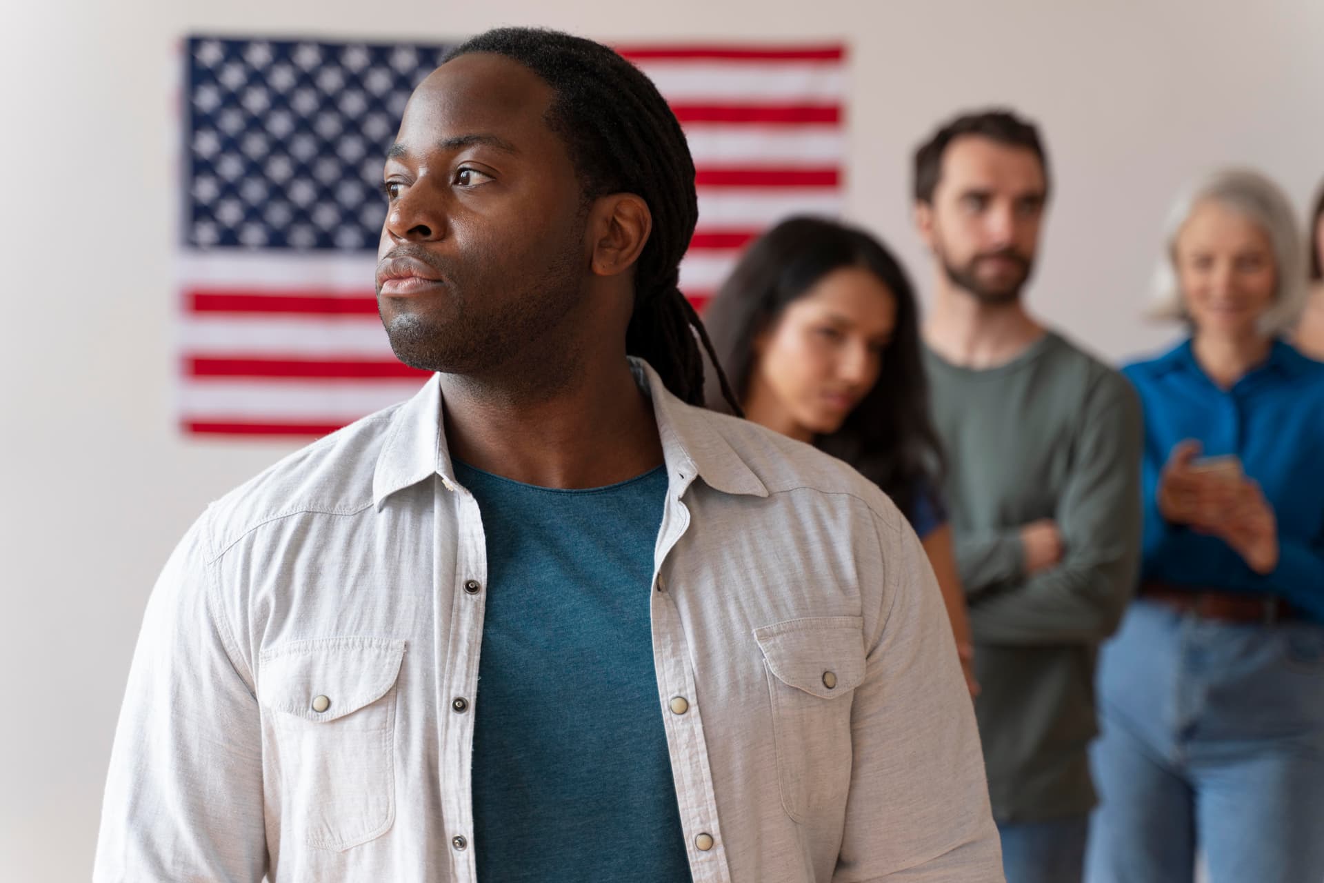 Stock photo: a group of people of different ages standing together in front of an American flag